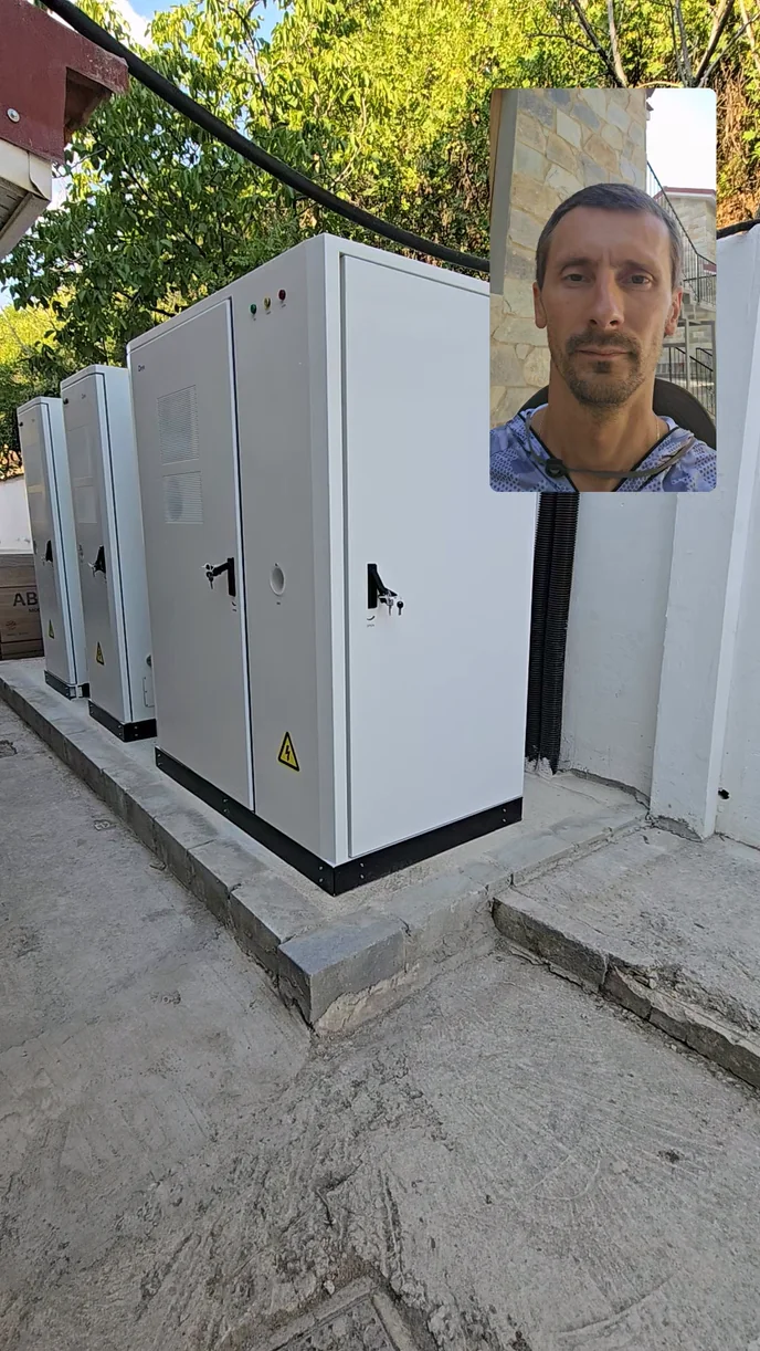Three white Deye All-in-one storage cabinets on a concrete base, with a presenter inset in the video frame